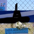 A bouquet of flowers and banners in support of the 44 crew members of the missing at sea ARA San Juan submarine are placed on a fence outside an Argentine naval base in Mar del Plata, Argentina November 25, 2017. The banner below reads "God, give strenght to the submariners".  REUTERS/Marcos Brindicci